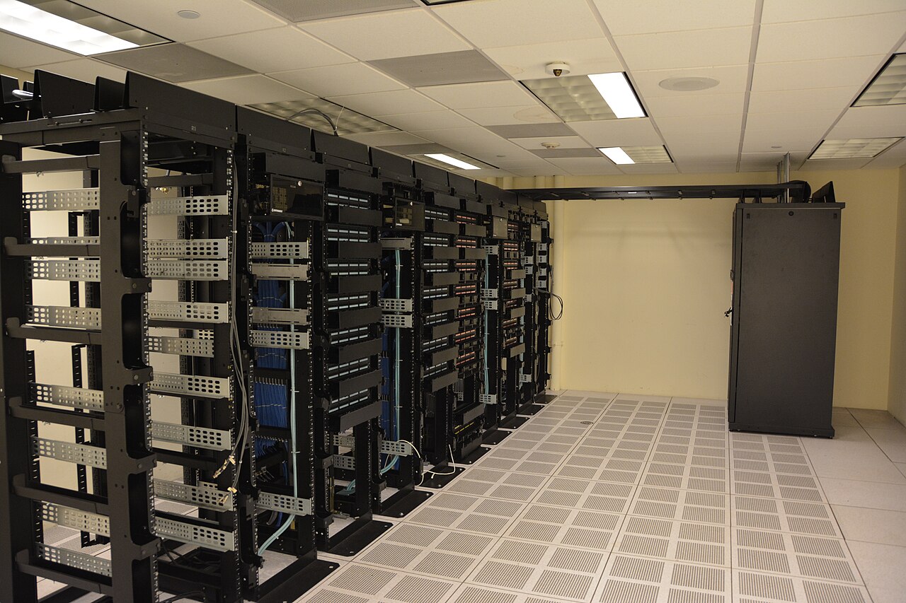 Rows of data center server racks where cloud misconfigurations like exposed AWS services and permissive firewalls go unnoticed