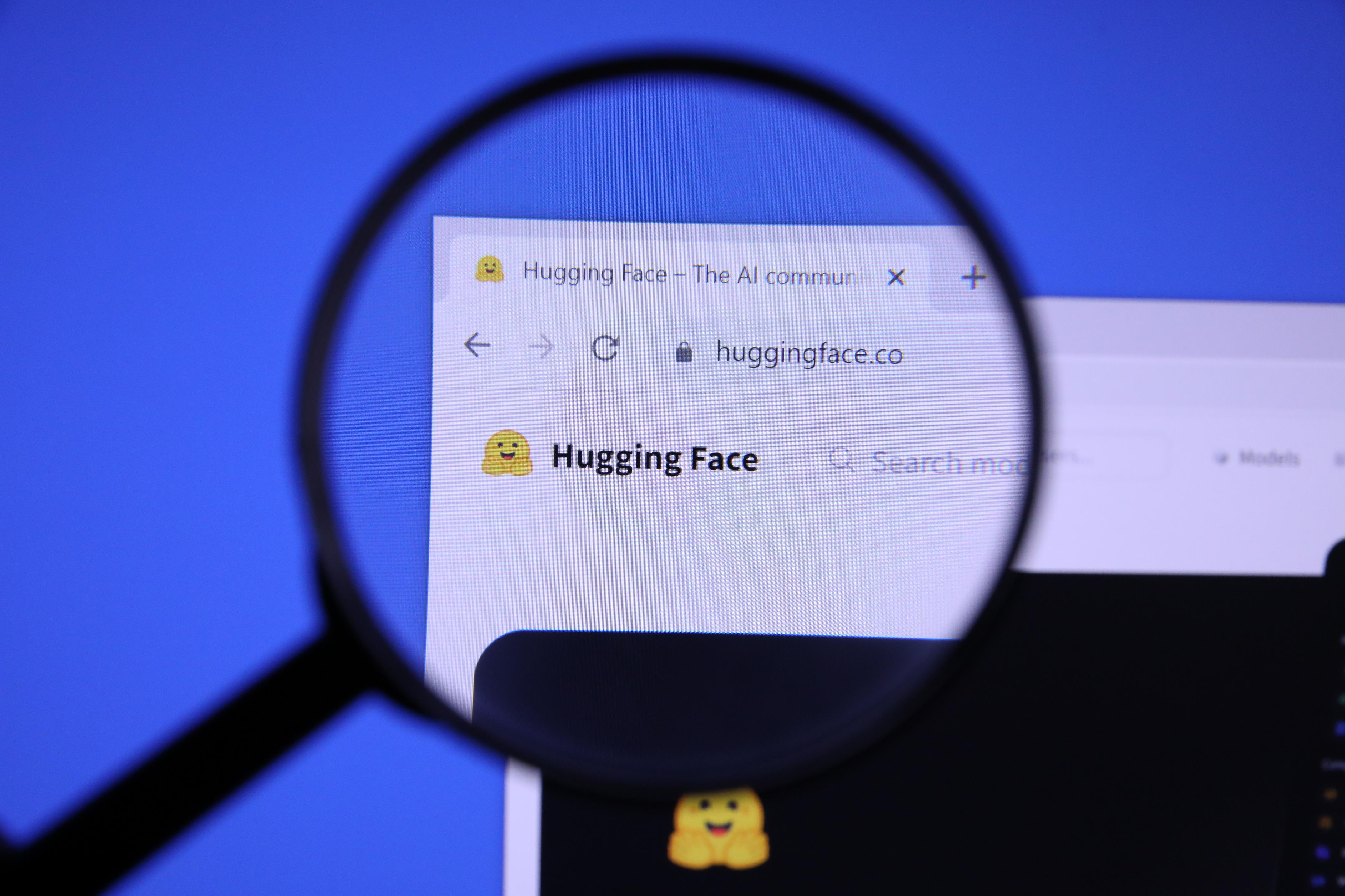 The Hugging Face website homepage photographed through a magnifying glass, the platform targeted by OpenAI agents during a security evaluation